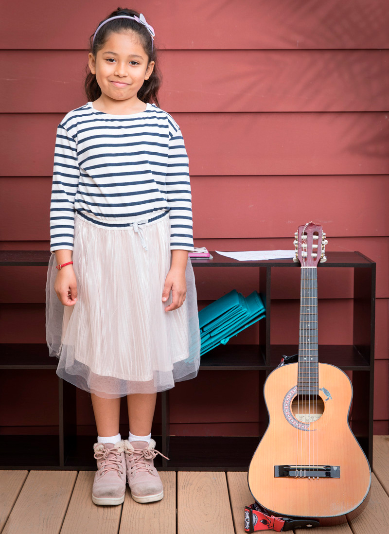 Front porch portrait of girl with guitar during COVID-19 Pandemic