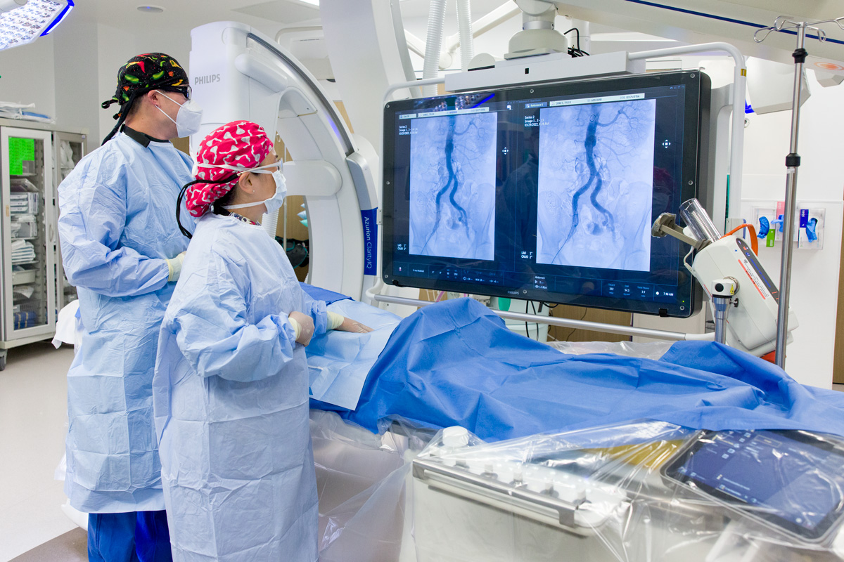 Photography of two surgeons in emergency operating room looking at Cardiac heart ablation procedure.