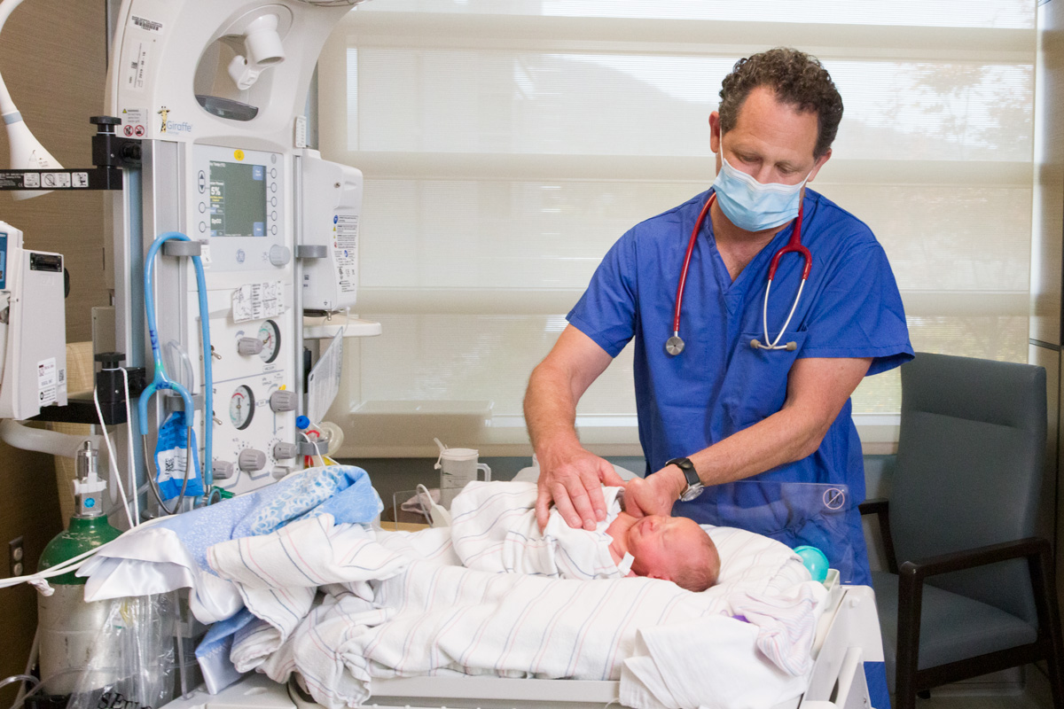 Photography of a Pediatrician in hospital examines newborn baby in the NICU Neonatal Intensive Care Unit