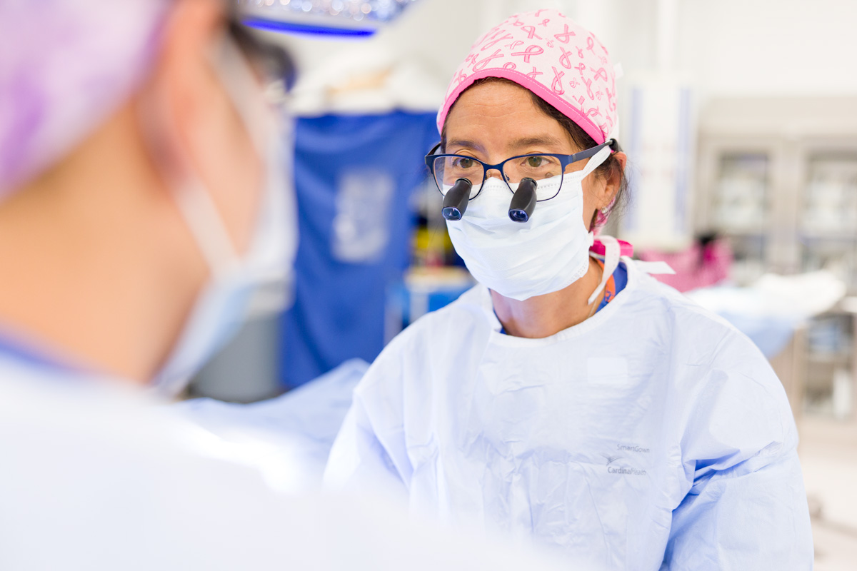 Picture of surgeon in operating room at hospital wearing operating room scrubs