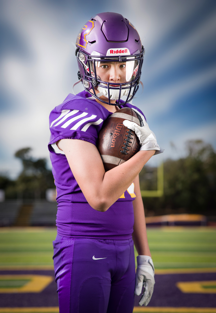 High school football athlete photographed on sports field