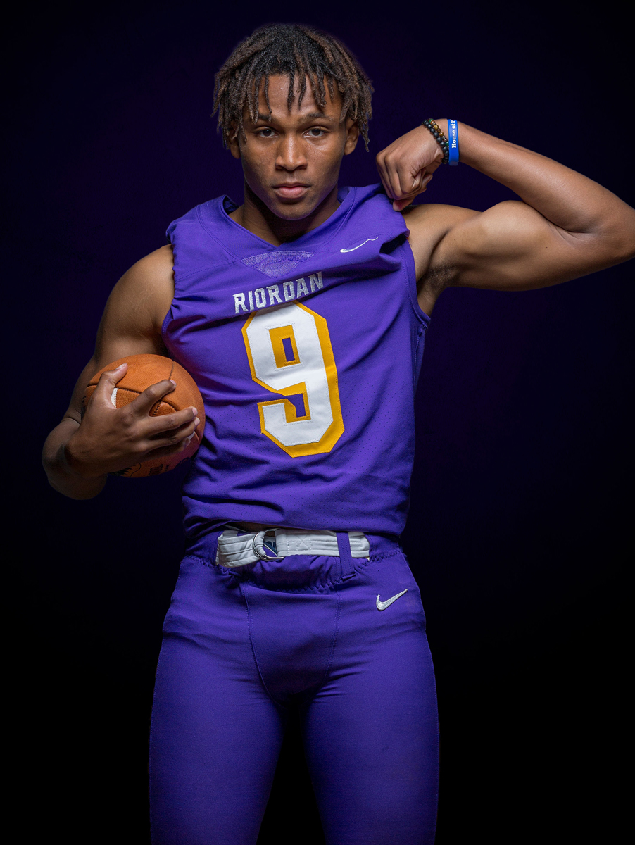 Football player in photo studio lit by strobes